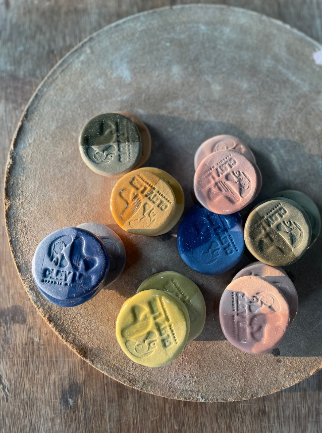 coins showing different shades of stoneware clay powder