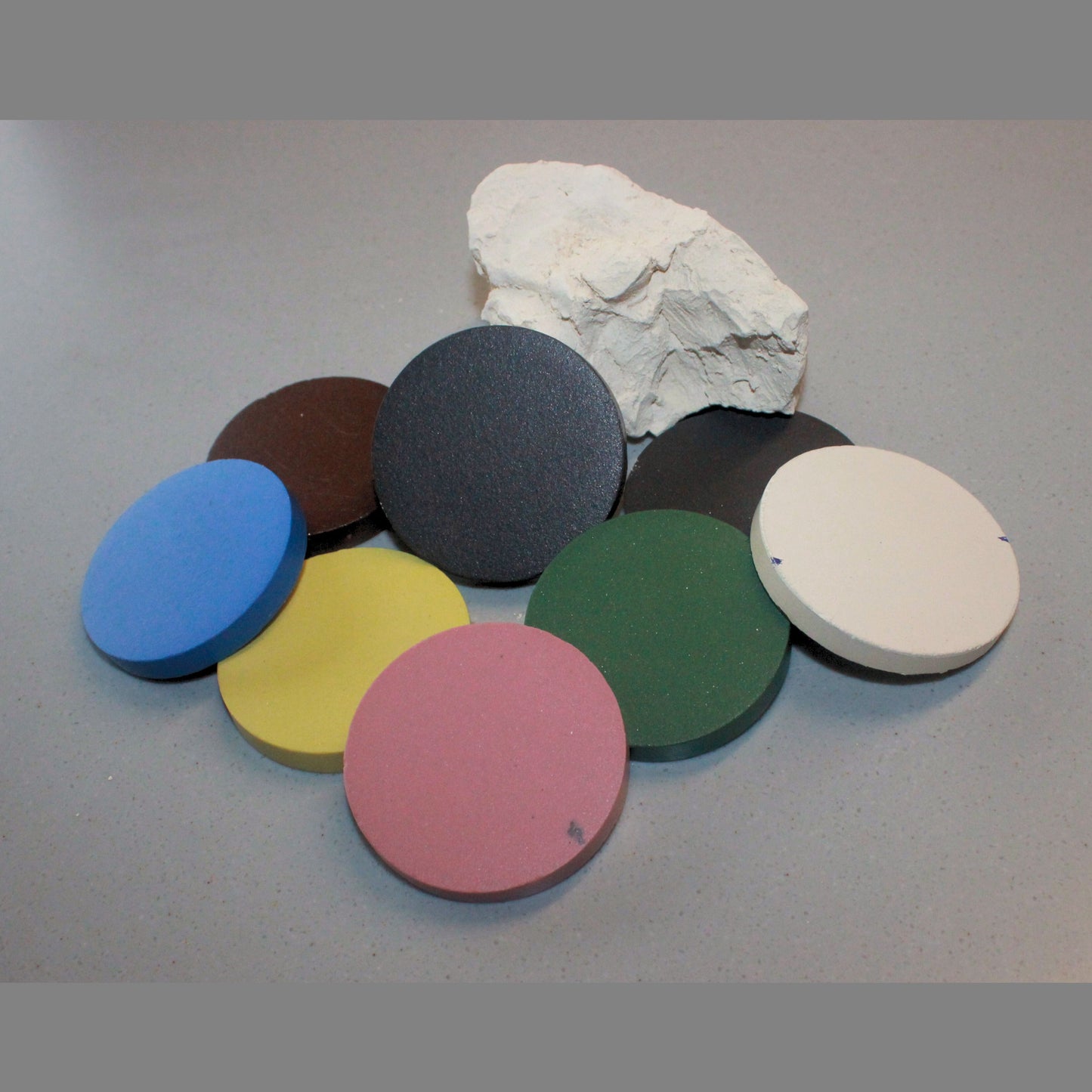 8 discs showing different colours of stoneware clay
