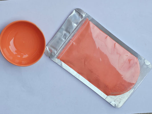 Orange Glaze in a sealed packet with a bowl of that colour