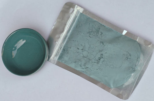 Peacock blue glaze stain in a sealed packet with a bowl of that colour