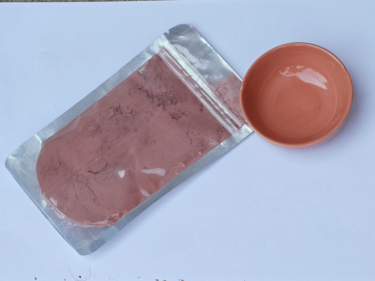 Pink Glaze in a packet with a pink bowl on the side