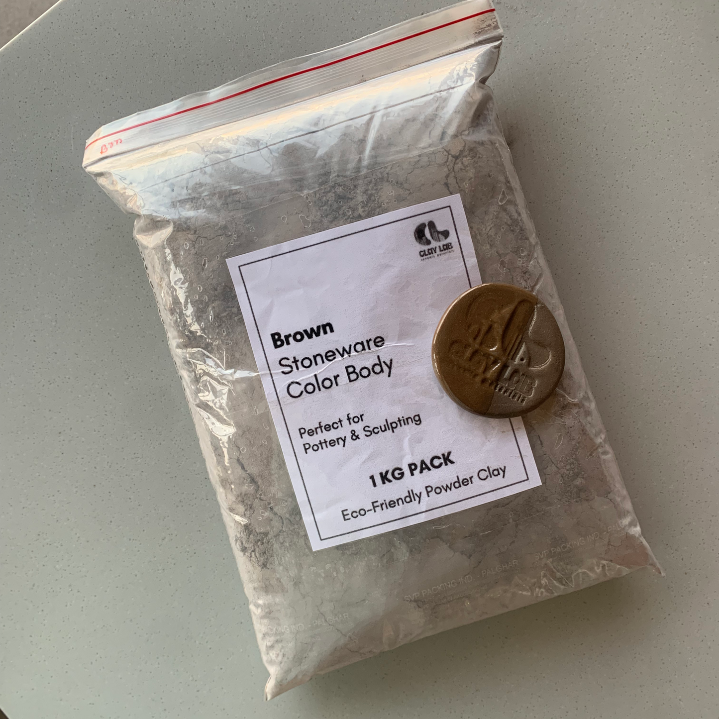 A seal pack bag of dark brown clay powder of 1kg