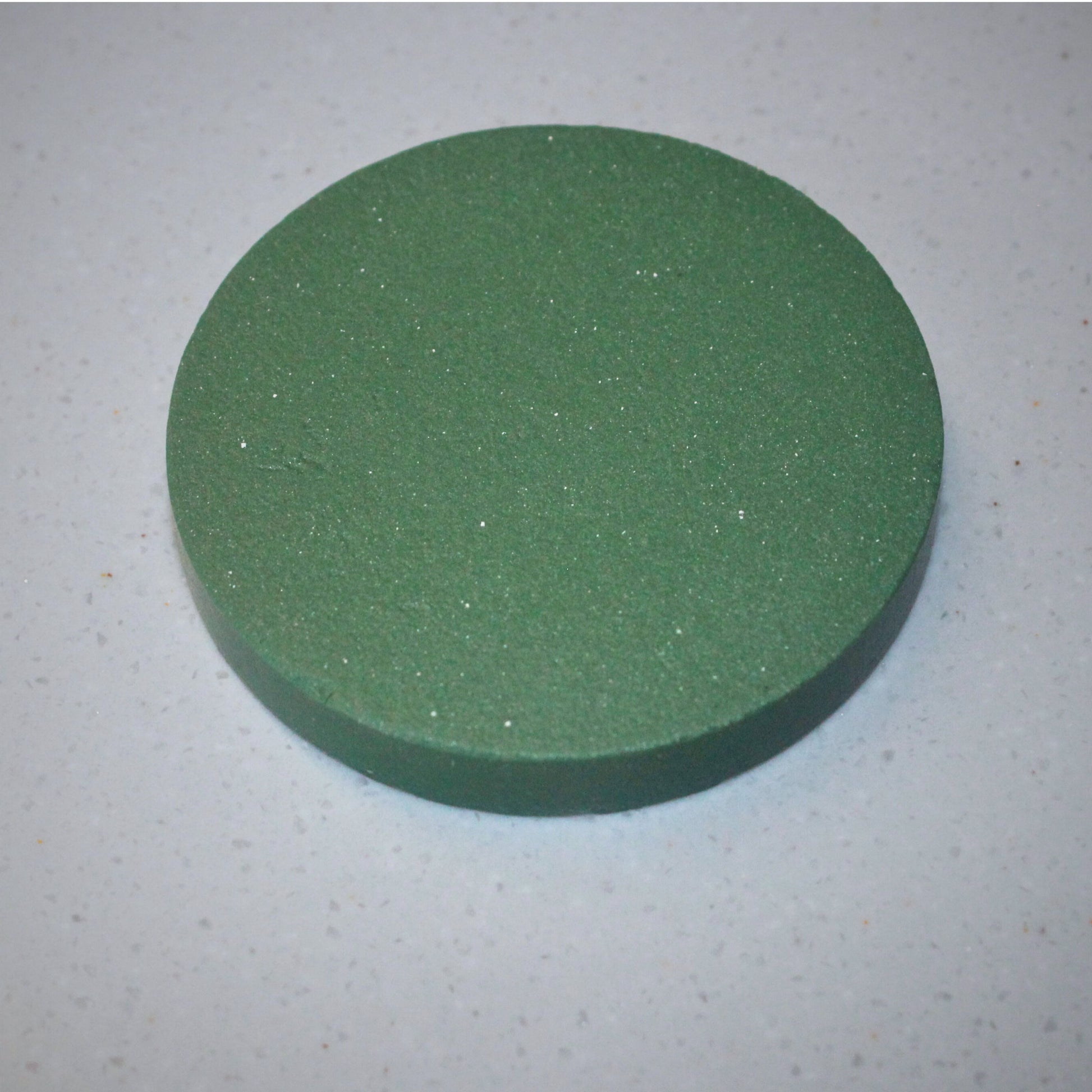 A disc made from green stoneware clay