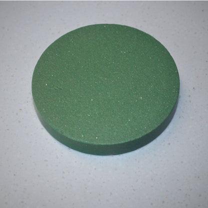 A disc made from green stoneware clay