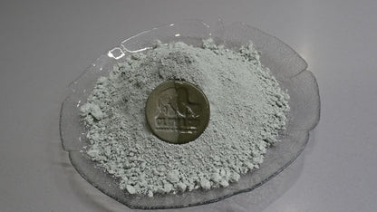 green clay powder in a bowl with top view