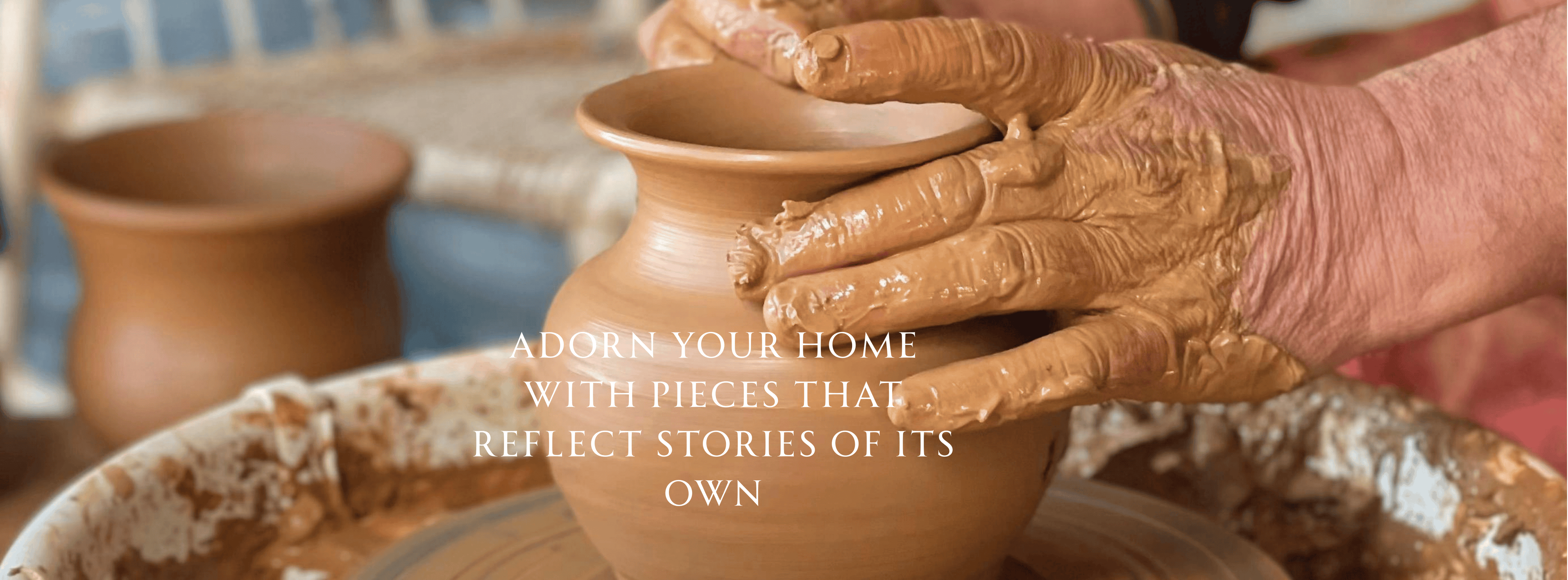 Handmade clay pot with a potter's wheel and hands