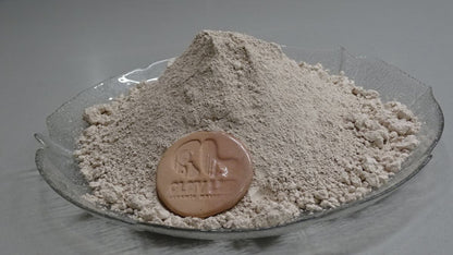 side view of pink stoneware clay body in a plate with a coin of its actual color