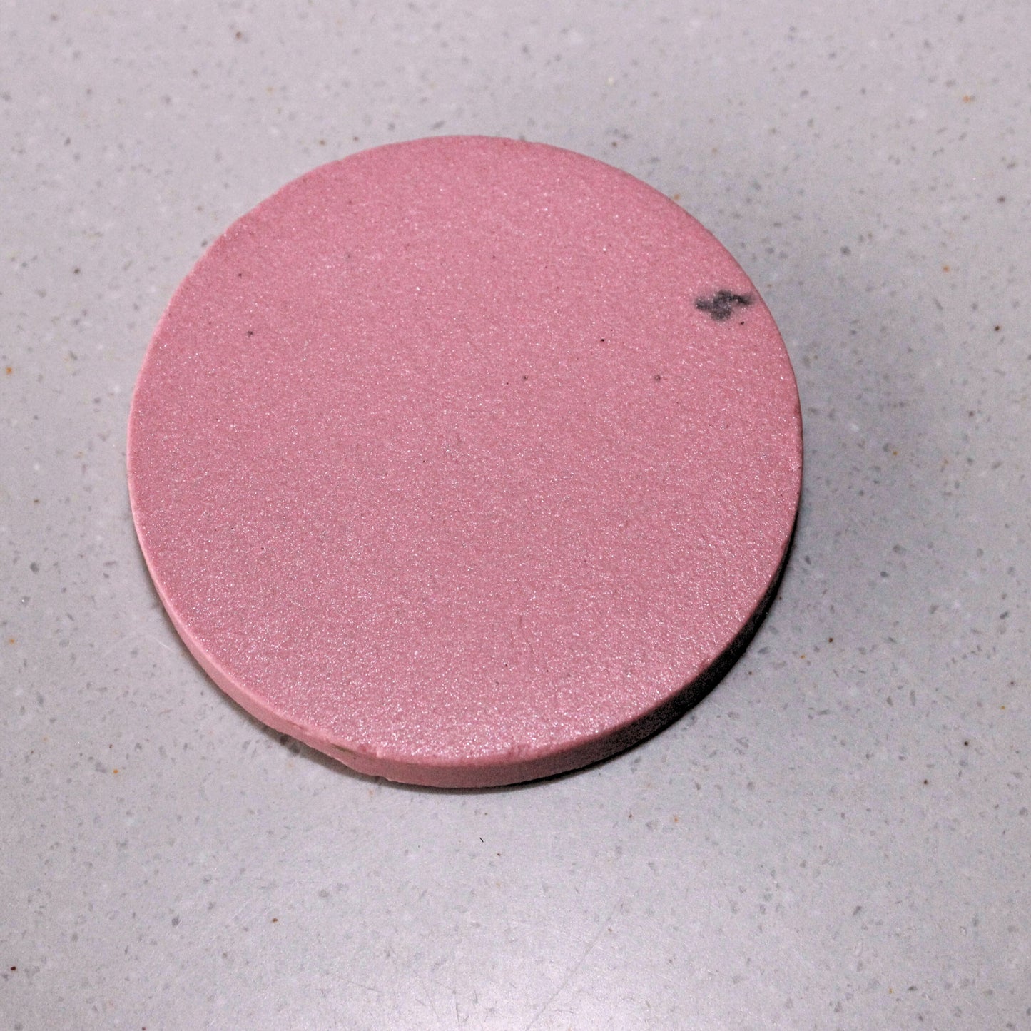 A disc made from pink stoneware clay body