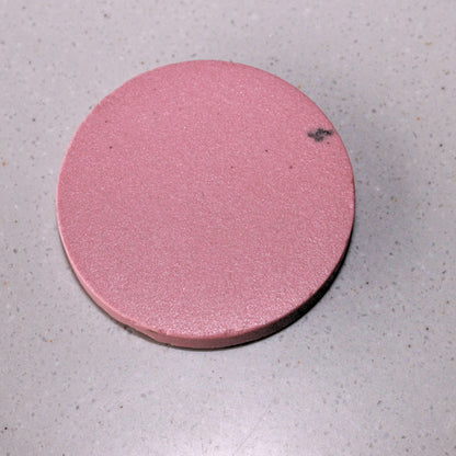 A disc made from pink stoneware clay body